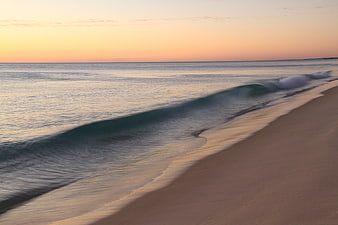 Serene Sunset Beach with Gentle Waves and Sandy Shore