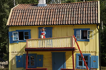 Pippi Longstocking Character on Yellow House Balcony