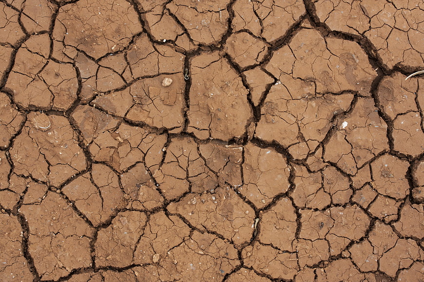 Close-up of cracked dry earth texture background