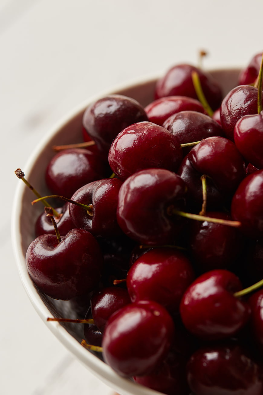 Fresh Red Cherries in a White Bowl Close Up