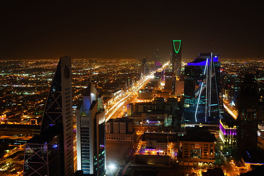 Riyadh skyline at night with illuminated skyscrapers and traffic
