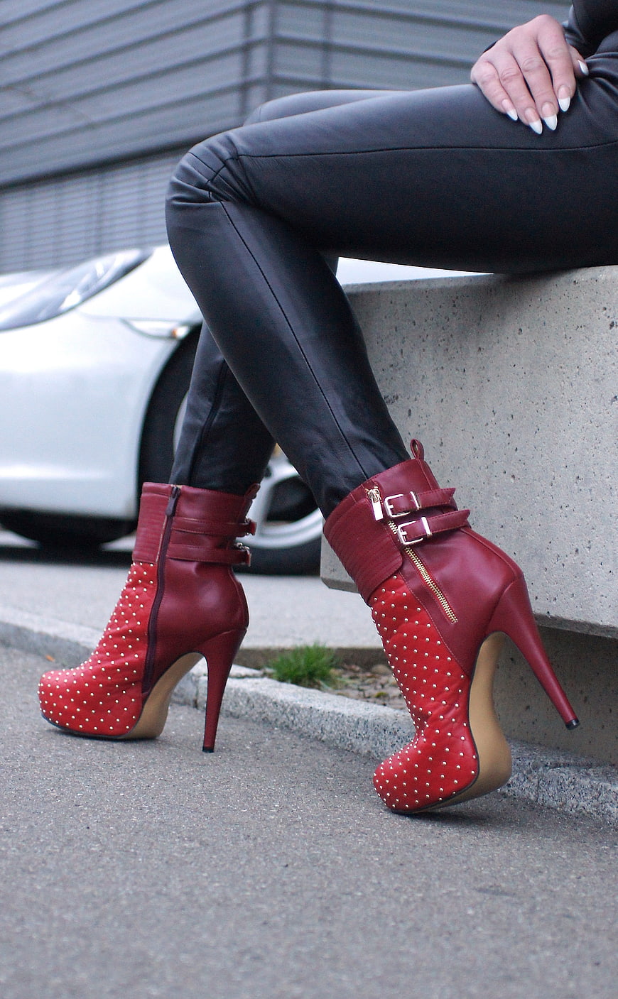 Red Studded High Heel Boots on Woman in Black Pants