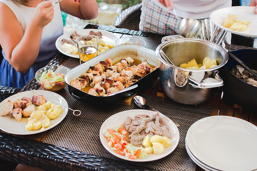 Family Feast with Roasted Chicken and Potatoes Outdoors