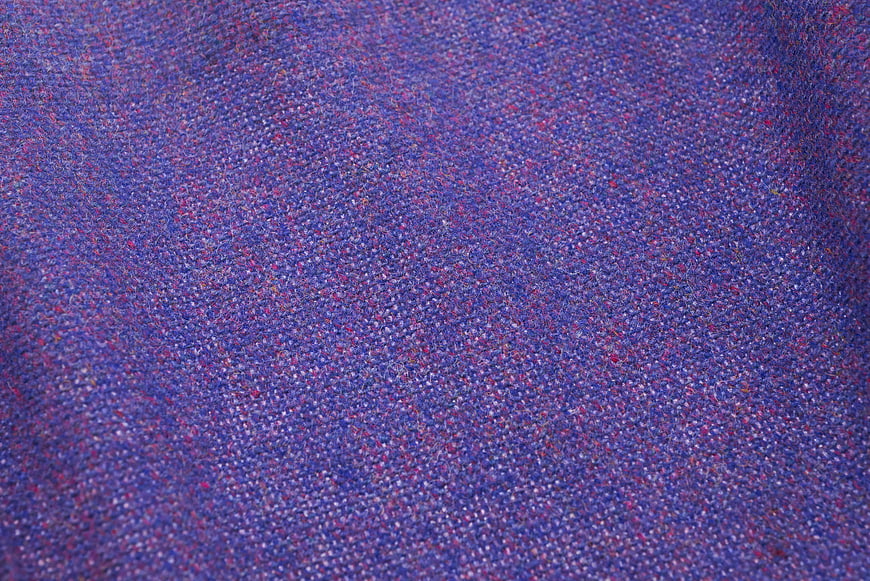 Close-up of purple and pink tweed fabric texture