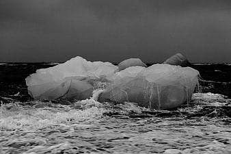 Dramatic Black and White Iceberg in Rough Ocean Waves