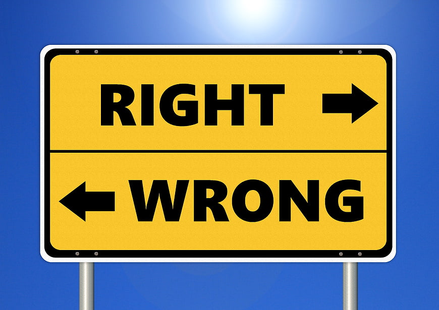 Yellow Road Sign Pointing Right and Wrong Directions