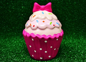 Pink Ceramic Cupcake Decoration with Bow on Green Background