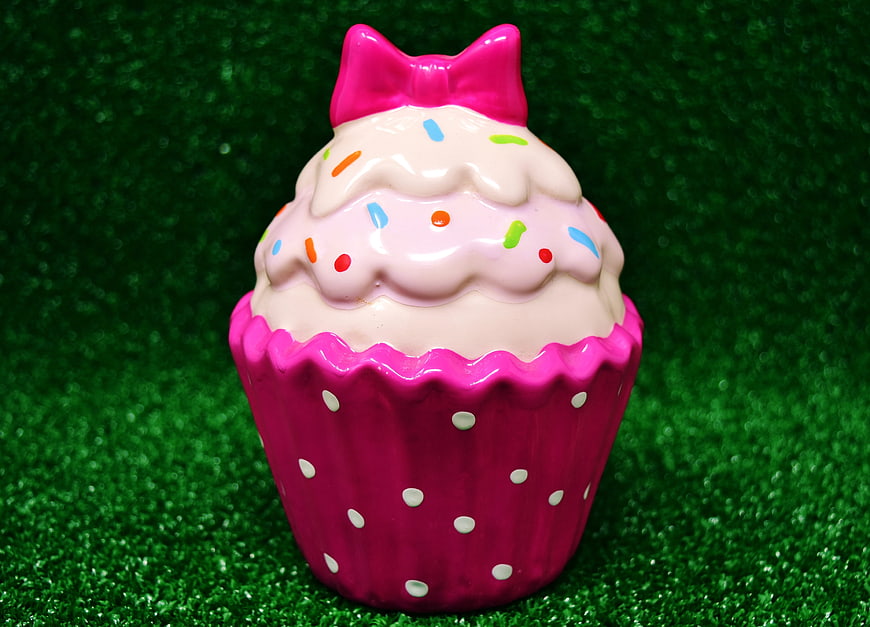 Pink Ceramic Cupcake Decoration with Bow on Green Background