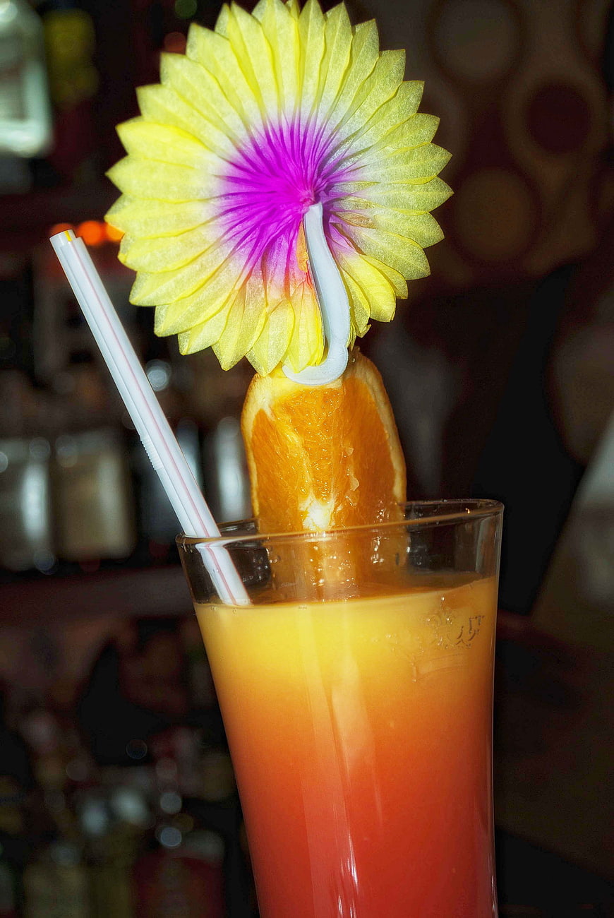 Tropical cocktail with paper umbrella and orange slice