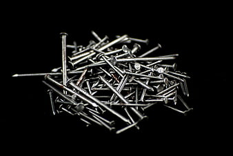 Pile of Silver Metal Nails on Black Background