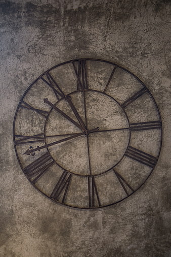 Vintage Metal Wall Clock on Textured Concrete Wall