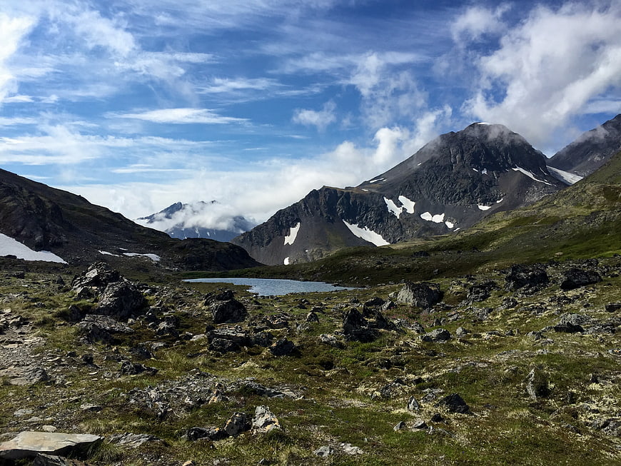 Scenic Alaska Mountain Landscape with Alpine Lake and Snow Patches