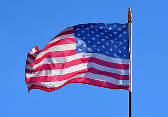 American Flag Waving Against Clear Blue Sky