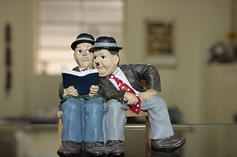 Vintage Couple Figurine Reading Book On Wooden Bench