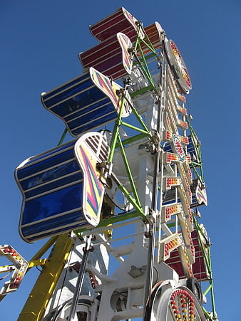 Colorful Zipper Amusement Park Ride Against Blue Sky