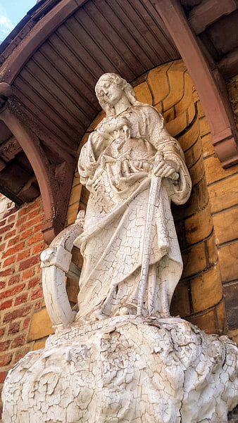 Weathered White Religious Statue in Architectural Niche