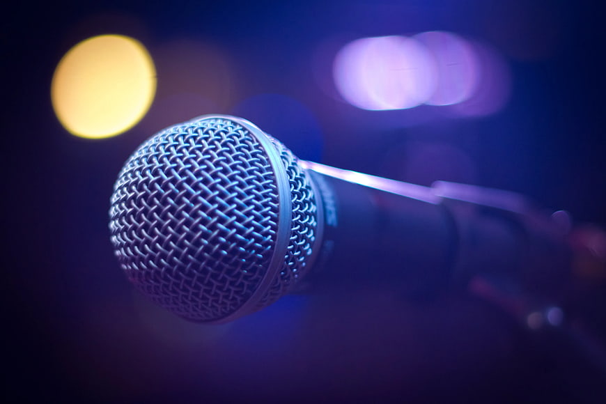 Close-up of microphone with colorful bokeh background