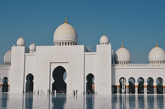 Sheikh Zayed Grand Mosque exterior with white marble domes and reflections