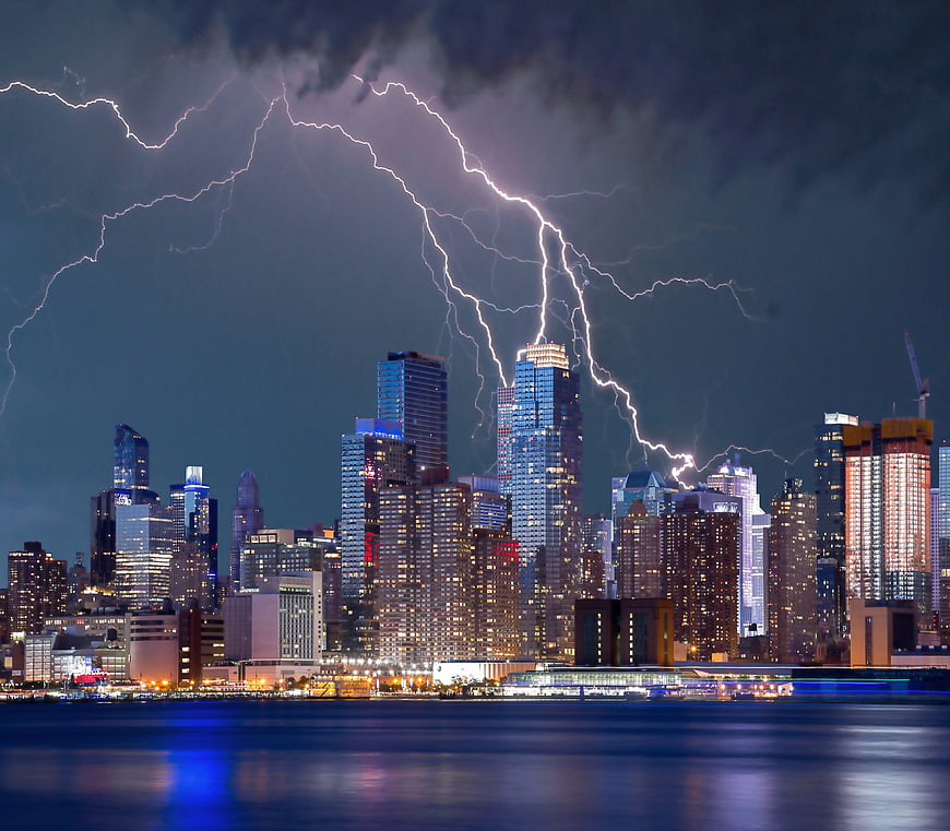 Dramatic Lightning Storm Over City Skyline at Night