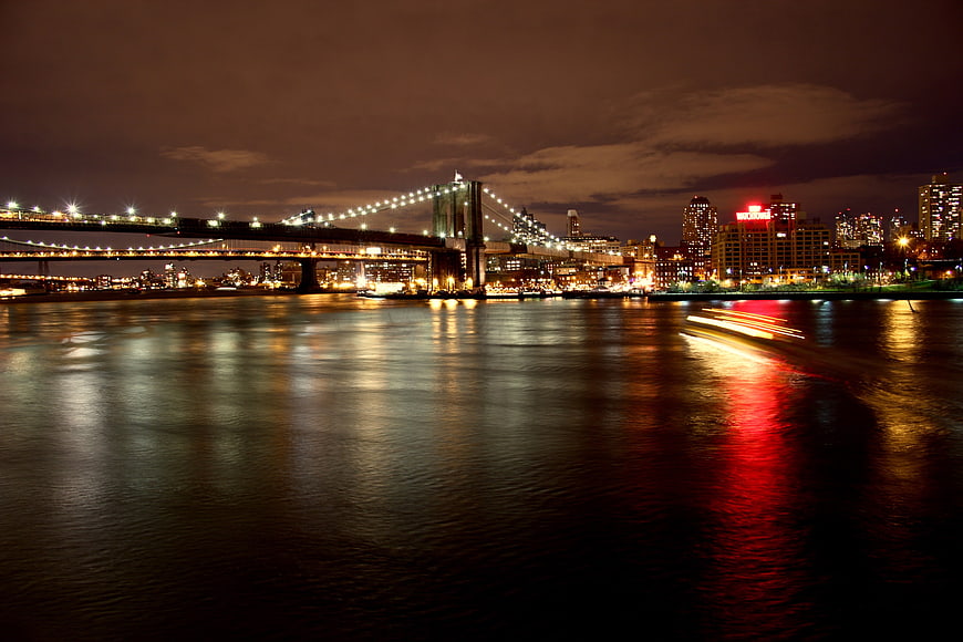 New York City Skyline at Night with Bridge and Light Trails