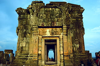 Ancient Khmer temple doorway with intricate stone carvings