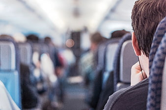 Man listening to music on a bus with blurred background