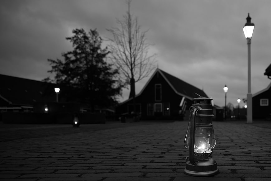 Vintage Lantern on Cobblestone Street at Night