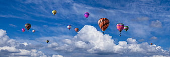 Colorful Hot Air Balloons Flying in Blue Sky with Clouds