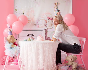 Woman having a whimsical tea party with teddy bears