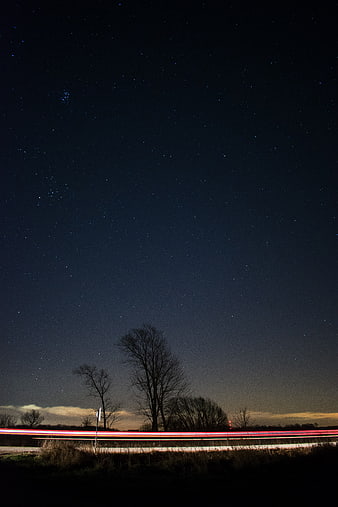 Long Exposure Night Sky with Starry Background and Car Light Trails