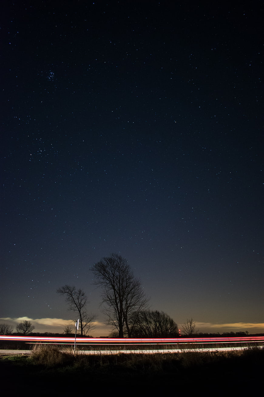 Long Exposure Night Sky with Starry Background and Car Light Trails