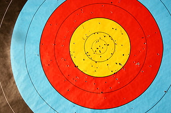 Close-up of archery target with arrows in bullseye
