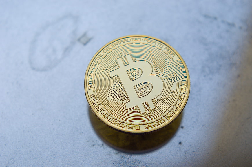 Gold Bitcoin Coin On Textured Surface