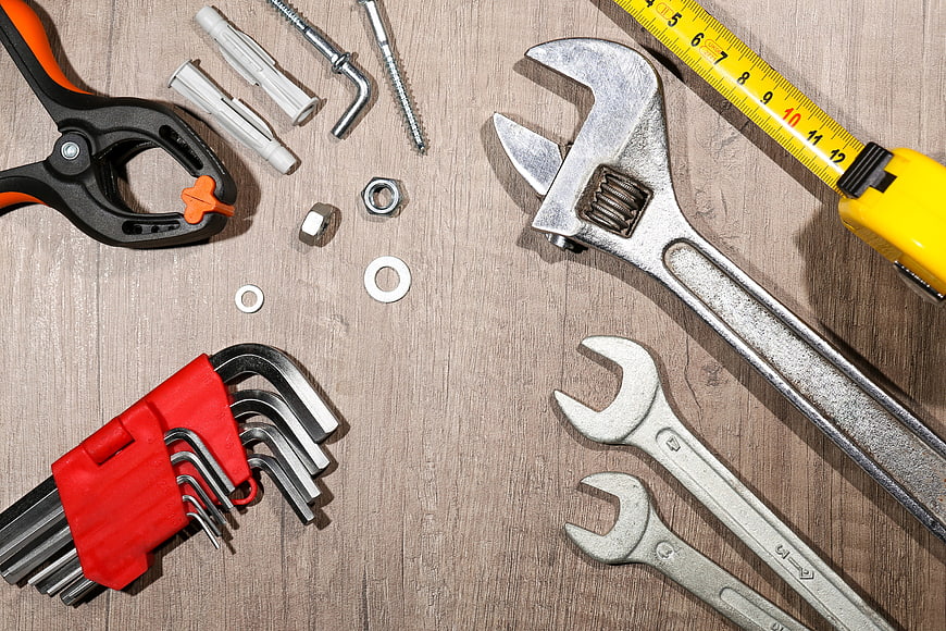 Flat lay of repair tools on wooden background with copy space