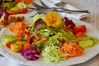 Colorful mixed salad platter with edible flower garnish