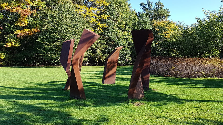 Abstract rusted metal sculptures in a green park