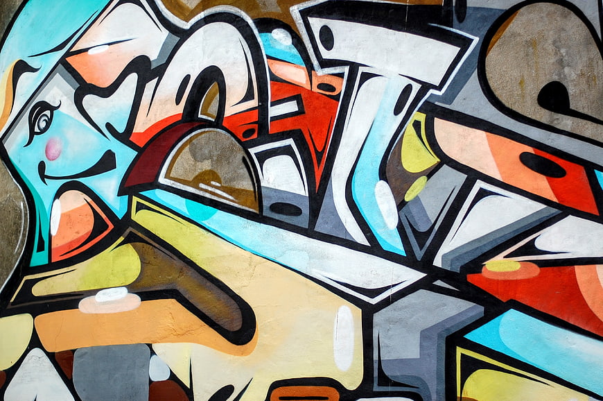 Colorful graffiti mural with cartoon character and abstract shapes