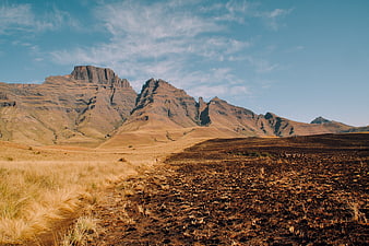 Dramatic Mountain Landscape with Golden Grass and Blue Sky