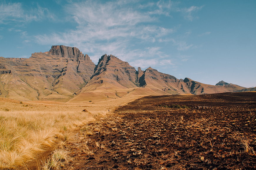 Dramatic Mountain Landscape with Golden Grass and Blue Sky