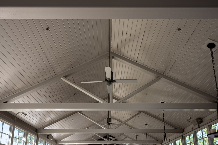 White Vaulted Ceiling with Beams and Ceiling Fan
