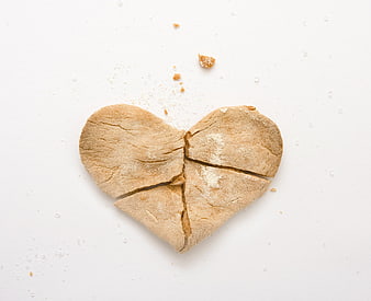 Broken heart-shaped cookie on a white background