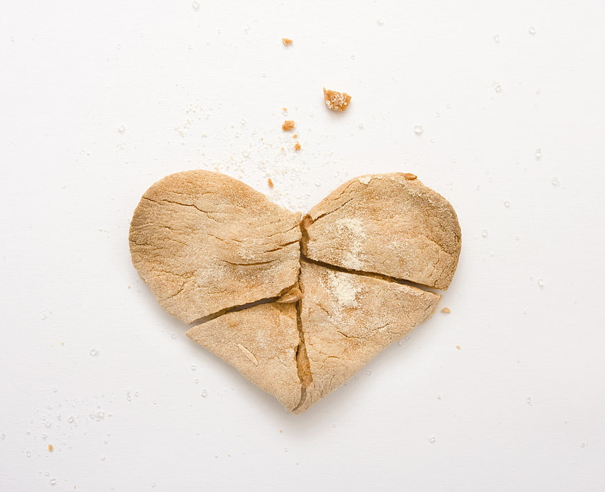 Broken heart-shaped cookie on a white background