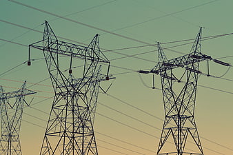 Silhouetted High Voltage Power Lines Against Gradient Sky