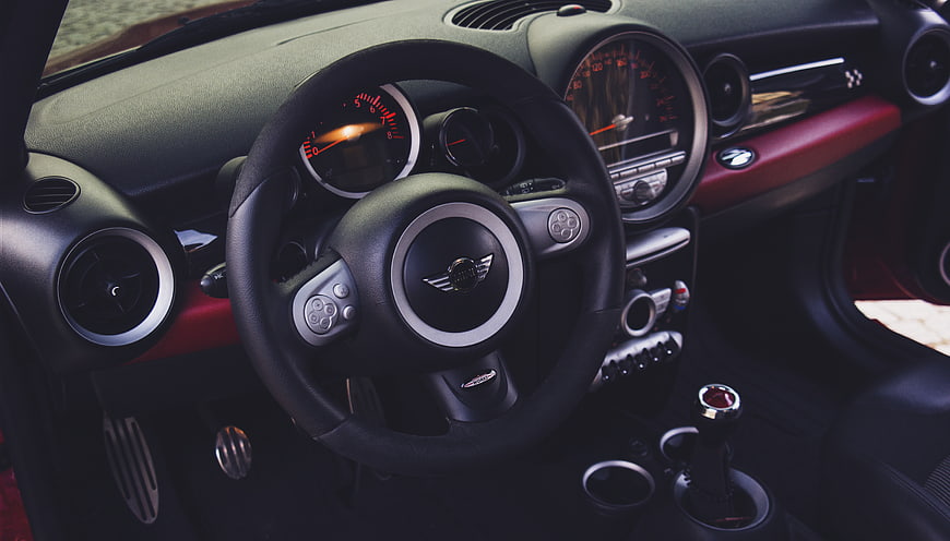 Interior of a Mini Cooper with steering wheel and dashboard