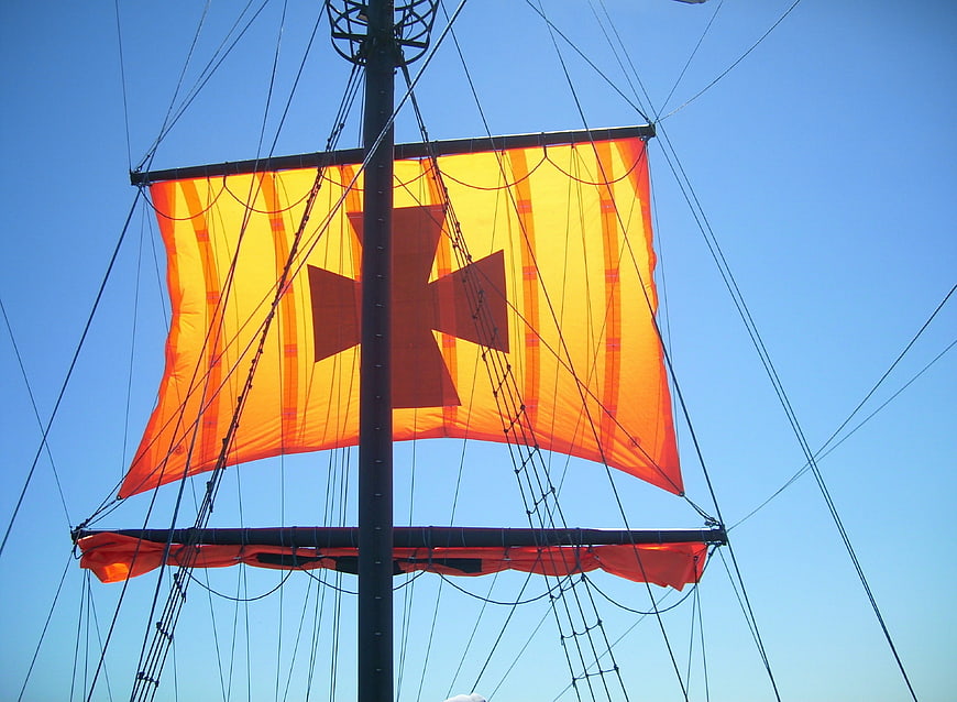 Orange Sail with Cross on Tall Ship Mast