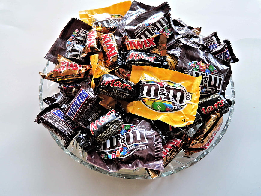 Glass bowl filled with assorted chocolate candy bars