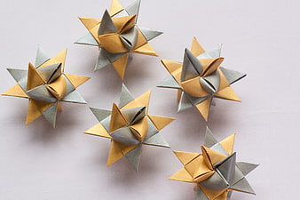 Gold and Silver Origami Stars on Light Background