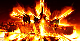 Close-up of burning wood logs with intense orange flames