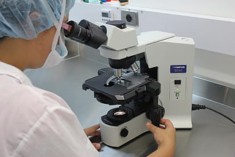 Scientist using microscope in laboratory