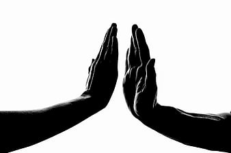 Silhouette of Two Hands Reaching for High Five